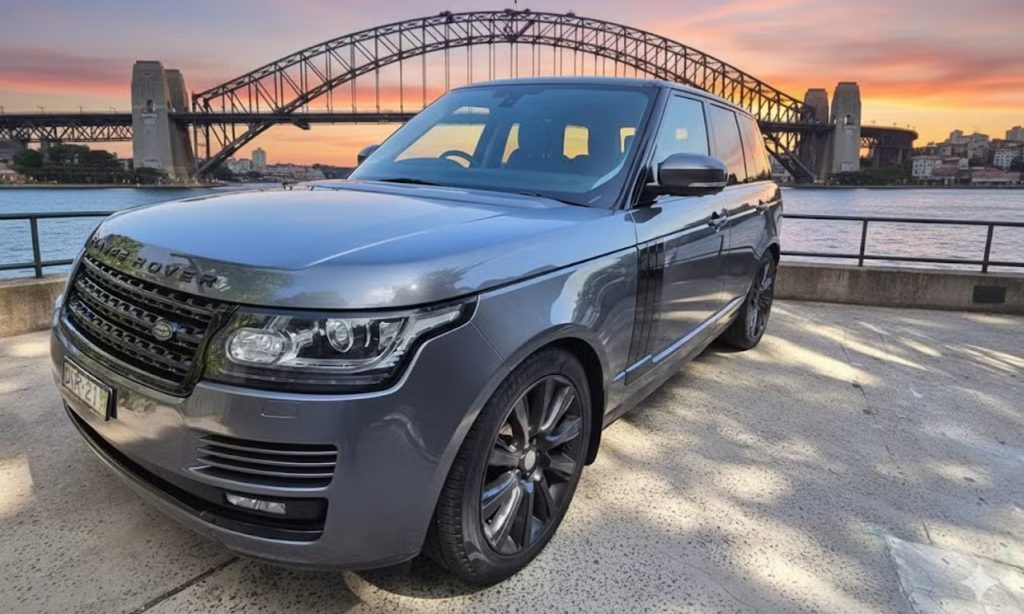 Grey 2013 Land Rover Range Rover Vogue, front three-quarter view, available for hire in Sydney