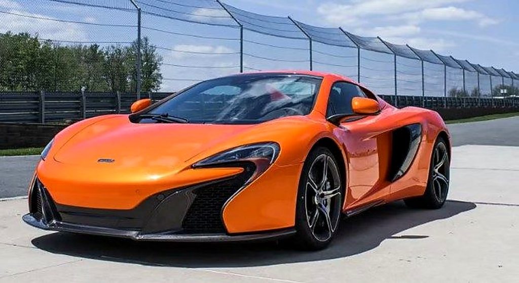 Orange 2015 McLaren 650S Coupe, front three-quarter view, available for hire in Sydney