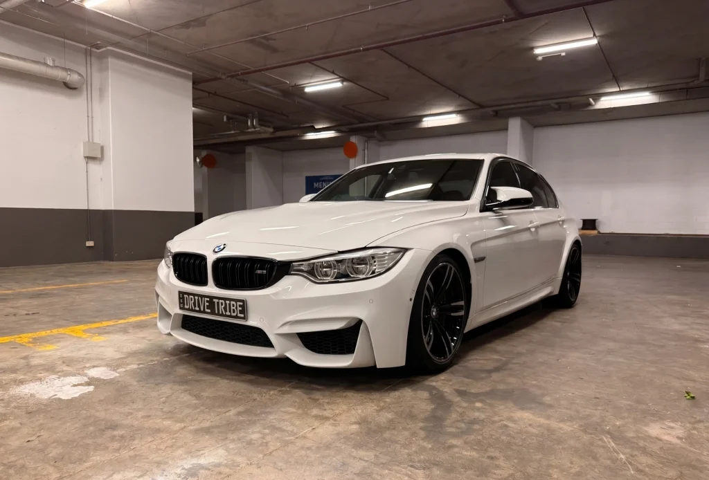 White 2016 BMW M3 Competition F80, front three-quarter view, available for hire in Sydney