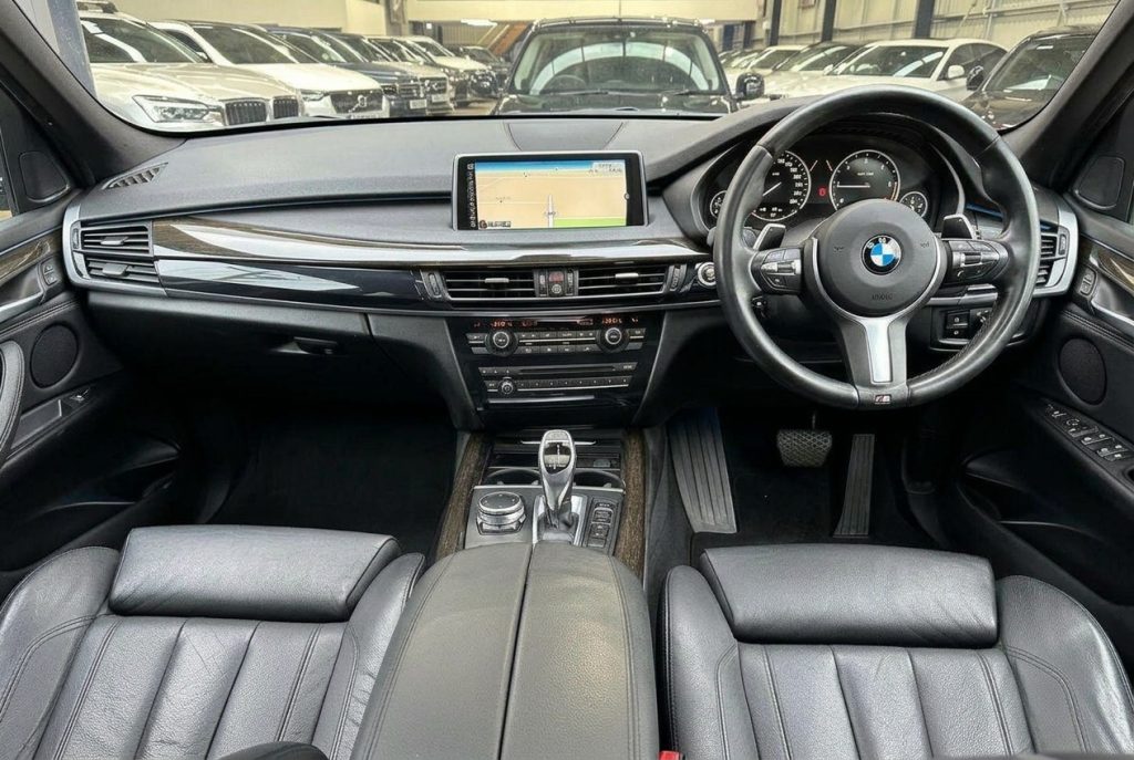 Dashboard of the white 2016 BMW X5 sDrive25d 7-Seat, available for hire in Sydney