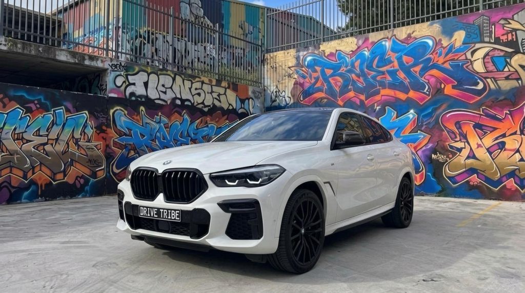 White 2022 BMW X6 xDrive40i M Sport, front three-quarter view, available for hire in Sydney